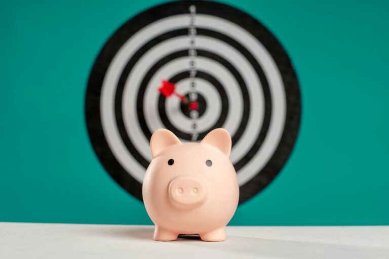 Piggy bank with bullseye dart board symbolizing financial goals and savings.